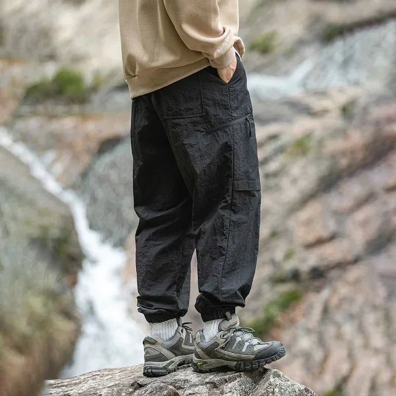 TFETTERS Autumn Men Cargo Pants 2025 Multi Pocket Waterproof Solid Color Casual Pants 100% Nylon Outdoors Tourism Men Clothes - Clikcy